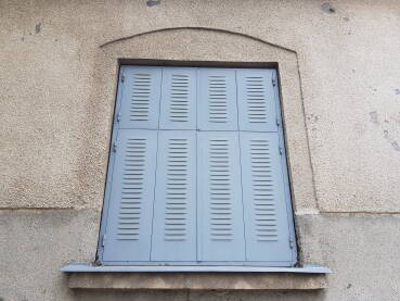 Zatvorene metalne plave žaluzine na prozoru