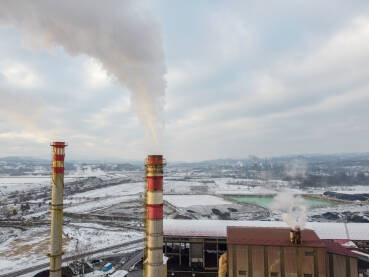 Dimnjak u tvornici ispušta zagađenje u okoliš, snimak dronom. Industrijsko onečišćenje zraka iz dimnjaka. Otrovni dim iz dimnjaka u industrijskoj zoni tokom zime. Industrijski kompleks