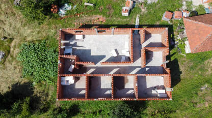 Kuća u izgradnji snimak dronom. Izgradnja kuće na selu. Zidovi od cigle na stambenoj kući. Gradilište.