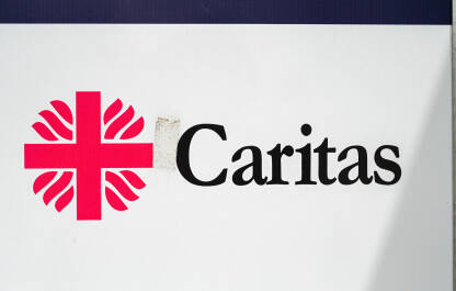 Simbol humanitarne organizacije Caritas. Kamp za migrante.