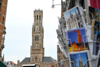 Bruges, Belgija: Srednjovjekovna kula sa satom na glavnom trgu. Poštanske razglednice. Historijske zgrade u centru grada.