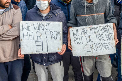 Grupa migranata drži banere sa parolama na protestu. Izbjeglice i migranti na Balkanskoj ruti. Demonstracije u kampu Lipa, Bihać. Ljudska prava.