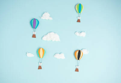Kreativan koncept, rukom šiveni baloni na svijetloj plavoj podlozi i oblacima od vate. Kapadokija, Turska, turističko putovanje.