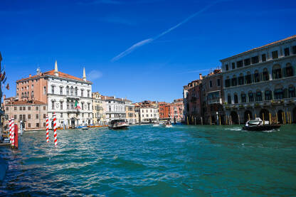 Venecija, Italija: Historijske građevine uz kanal. Čamci na vodi. Popularno turističko odredište.