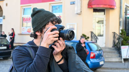Fotograf snima fotografije na ulici. Novinar na poslu.