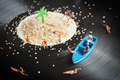 Figurice kupača na plaži na gramofonskoj ploči.