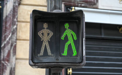 Zeleno svjetlo na semaforu za pješake. Semafor na ulici u Parizu, Francuska. Saobraćajni signal. Svjetlosna signalizacija.