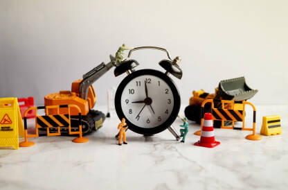 Figurice radnika i radnih mašina na crnom satu