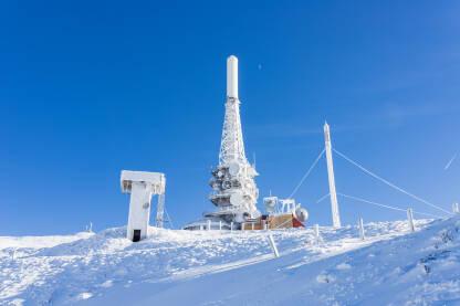 Smrznuti TV ili mobilni toranj prekriven  velikim snijegom. Telekomunikacijski tornjevi s antenom i mobilnom antenom. Planina Vlašić