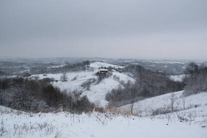 Zimski seoski pejzaž, seosko imanje na brdu