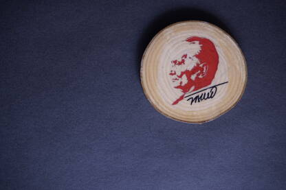 Suvenir s likom Josipa Broza Tita Suvenir s likom Josipa Broza Tita na tamnoj podlozi. Magnet, preslikana slika na komadu drveta. Tito je bio vođa jugoslavenskih partizana i predsjednik Jugoslavije