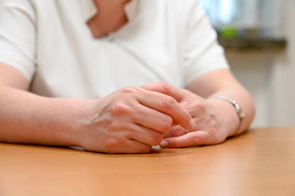 Ruke žene na stolu tokom razgovora. Ruke doktorice.