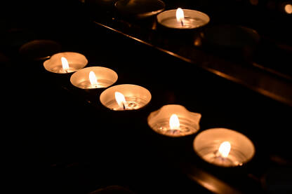 Svijeće u katedrali. U crkvi svijetle zapaljene svijeće.