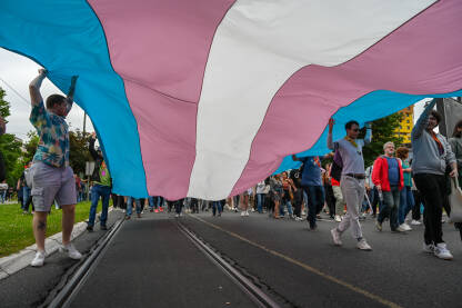 Ljudi nose veliku trans zastavu na Bh. povorci ponosa, 24. juna 2023. Protest za prava LGBTIQ zajednice u Bosni i Hercegovini.