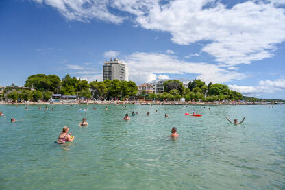 Vodice, Hrvatska: Ljudi na moru. Ljetni godišnji odmor. Turisti plivaju i zabavljaju se u vodi.