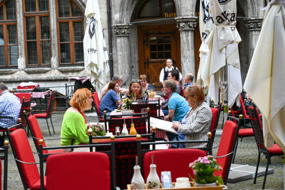 Ljudi sjede i jedu u restoranu. Turisti na ručku.