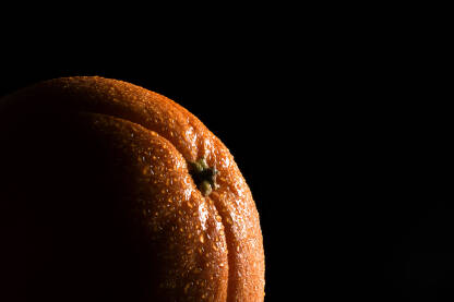 Makro fotografija narandže na crnoj pozadini