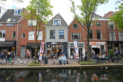 Delft, Nizozemska. Ljudi šetaju gradom. Zgrade, ulice i trgovi.