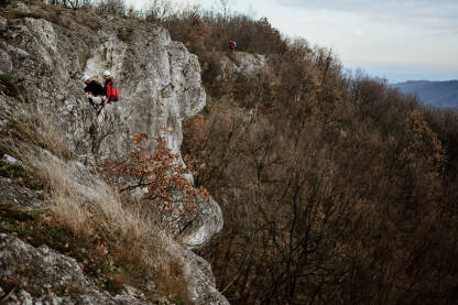 Planinari vježbaju spuštanje niz stijenu pomoću konopca.
