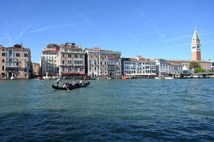 Venecija, Italija: Historijske građevine uz more. Popularna turistička destinacija. Gondola na vodi. Turisti istražuju grad.
